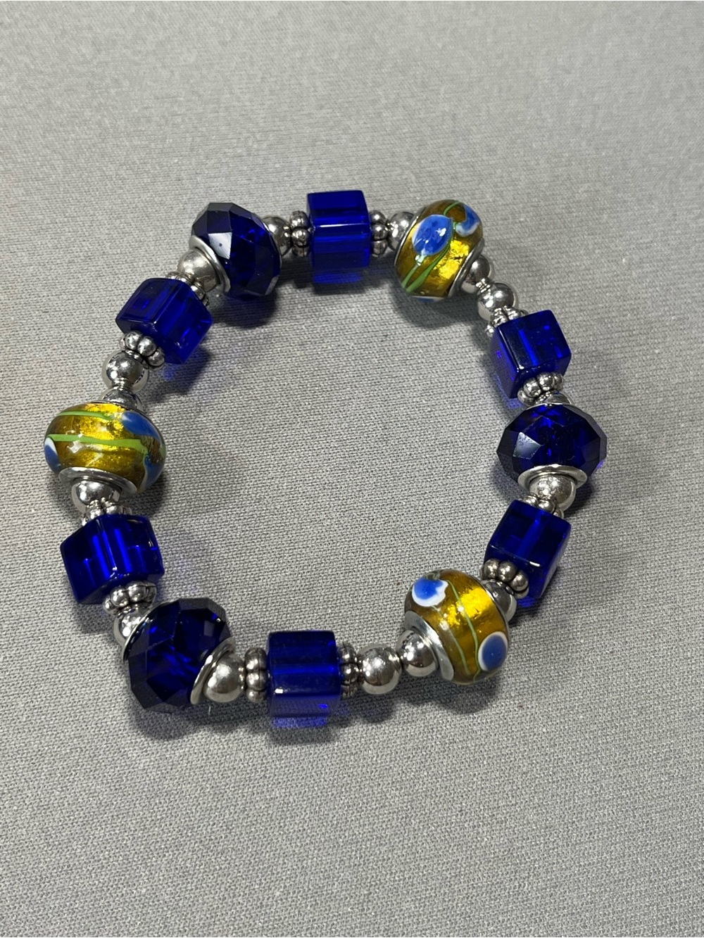 NWOT beautiful blue and yellow plastic beads with silver tone beads in between.